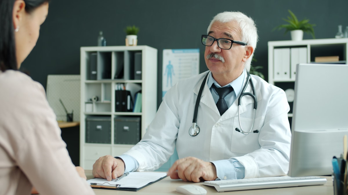 A physician reviewing preventive assessment results with a patient