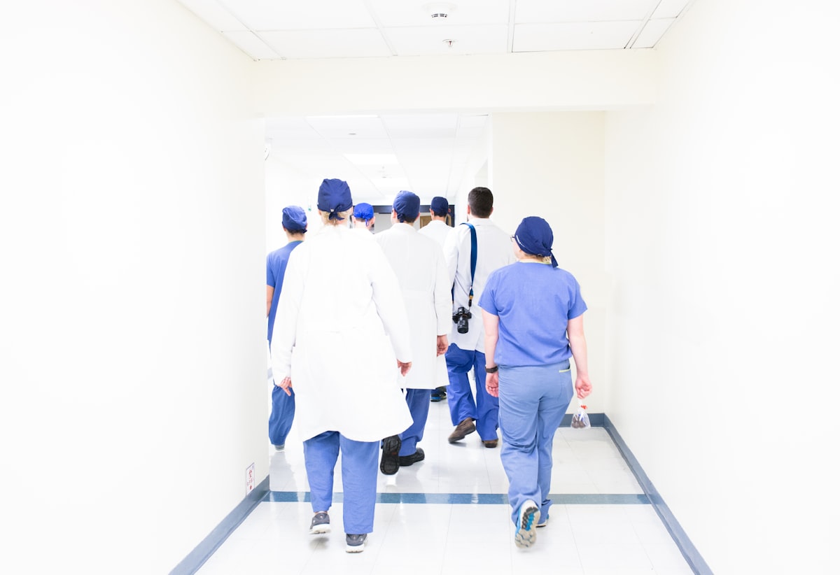 A team of physicians walking together through a hospital corridor